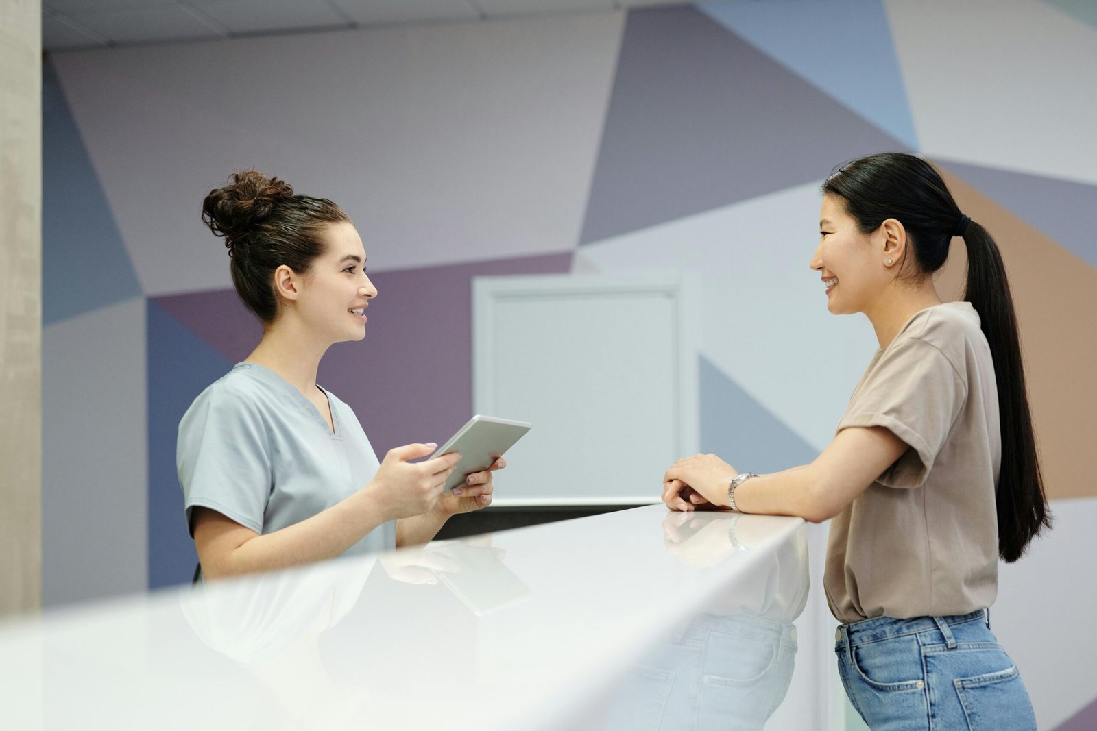 A Woman Talking to Physio Cure Medical Center's Receptionist