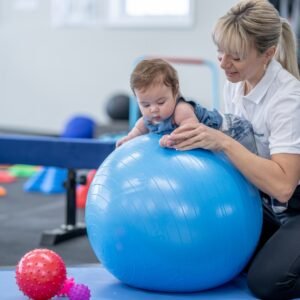 physiotherapist helping child, pediatric physiotherapy