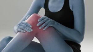 Woman holding knee in pain indicating ACL injury